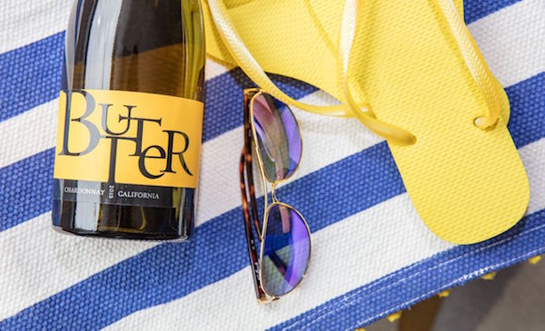 Bottle of JaM Cellars Butter, sunglasses, flip-flops
