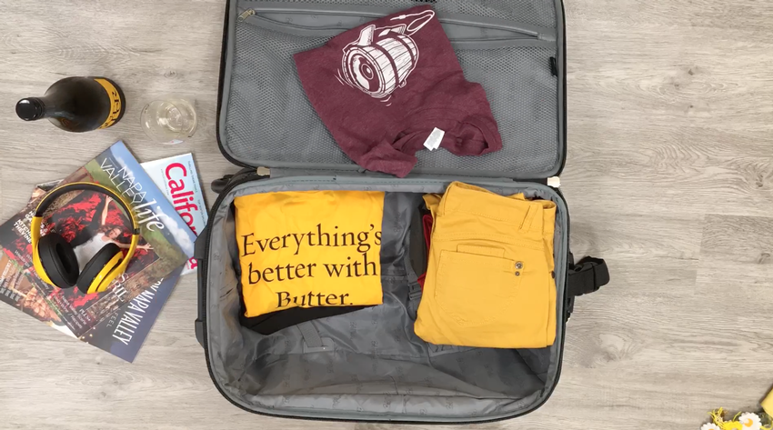 Items laid out for packing with bottle of JaM Cellars wine background