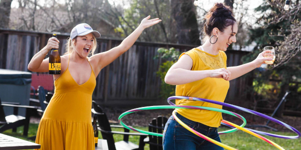 Two women enjoying JaM Cellars Butter and hula hooping