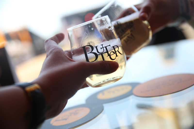 Hand holding out glass to be filled with JaM Cellars Butter