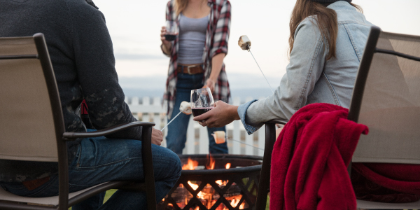 Toasting S'mores over outdoor fire and enjoying glasses of JaM Cellars wine