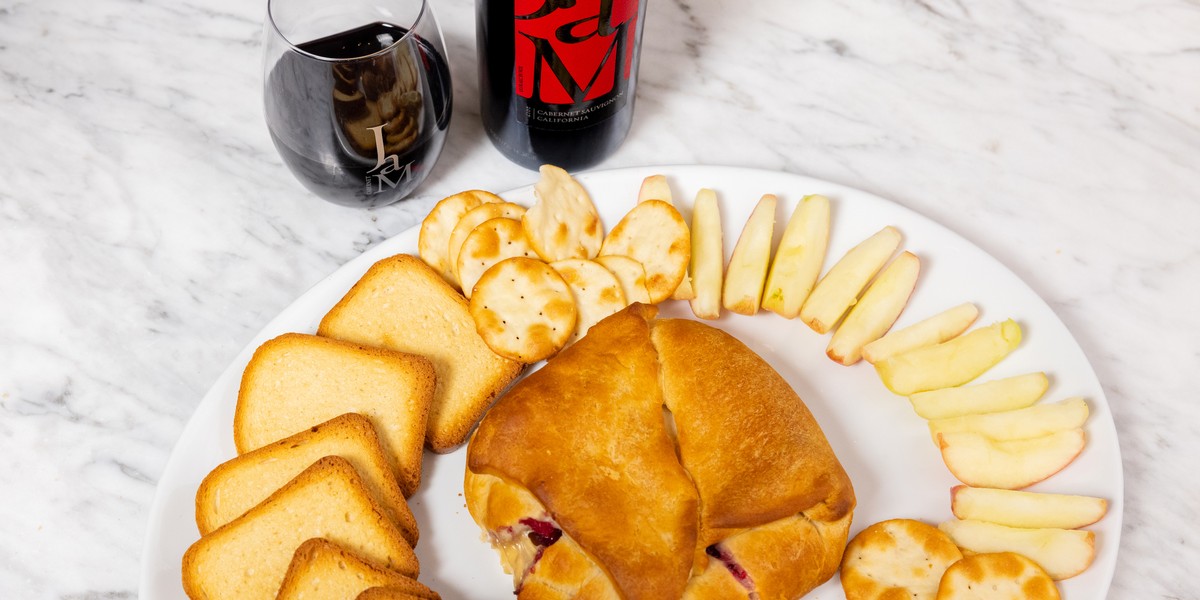 Baked brie in pastry with bottle of JaM Cellars wine