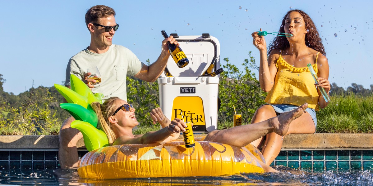 Three people enjoying JaM Cellars Butter wine at the pool.